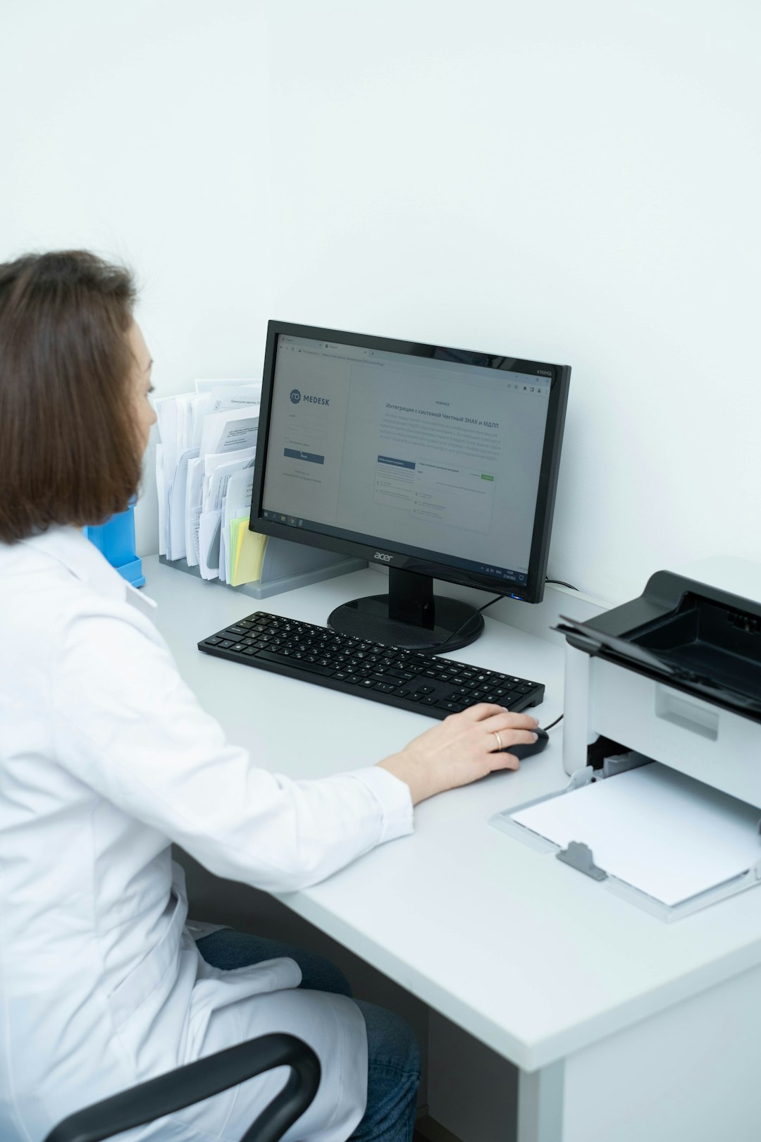 about-us-02 a-woman-sitting-at-a-desk-using-a-computer-0df7uzd2yd8